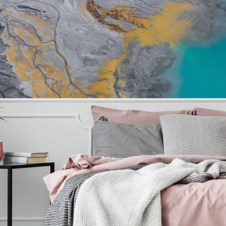 a bed with pink and grey pillows and a pink blanket