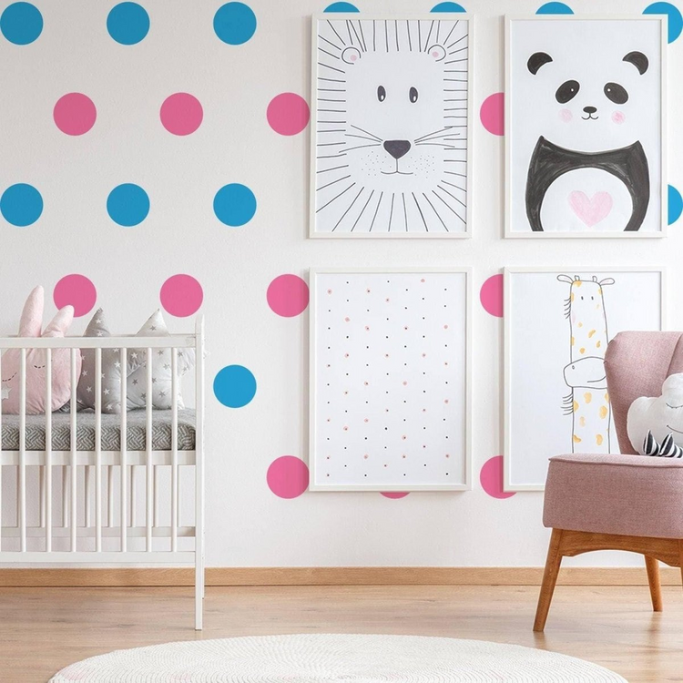 a baby room with a crib and pictures on the wall
