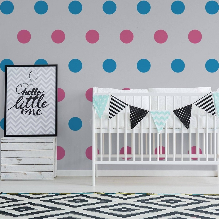 a baby room with a crib and a poster