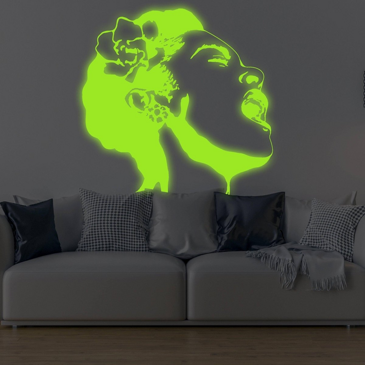 a couch with a glowing woman's face on the wall