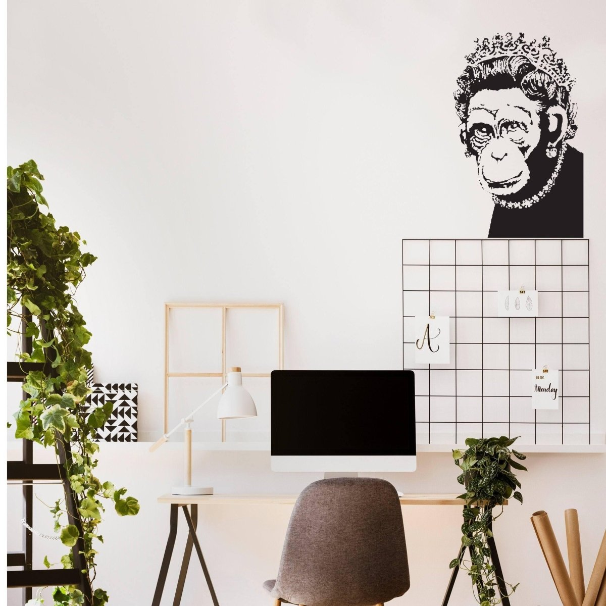 a desk with a computer and plants