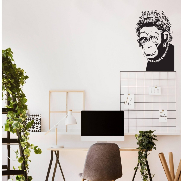 a desk with a computer and plants