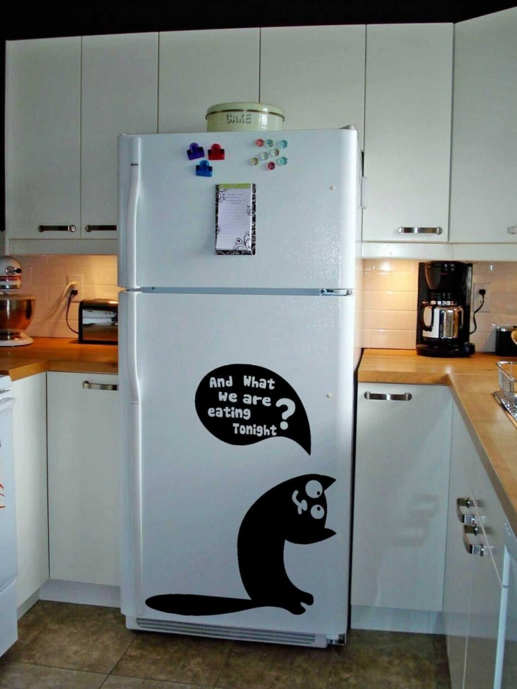 a white refrigerator with a black cat on it