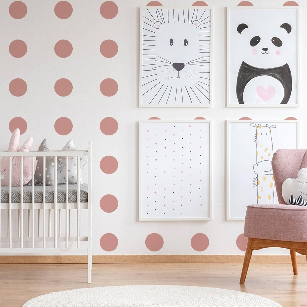 a room with pink polka dots and pictures on the wall