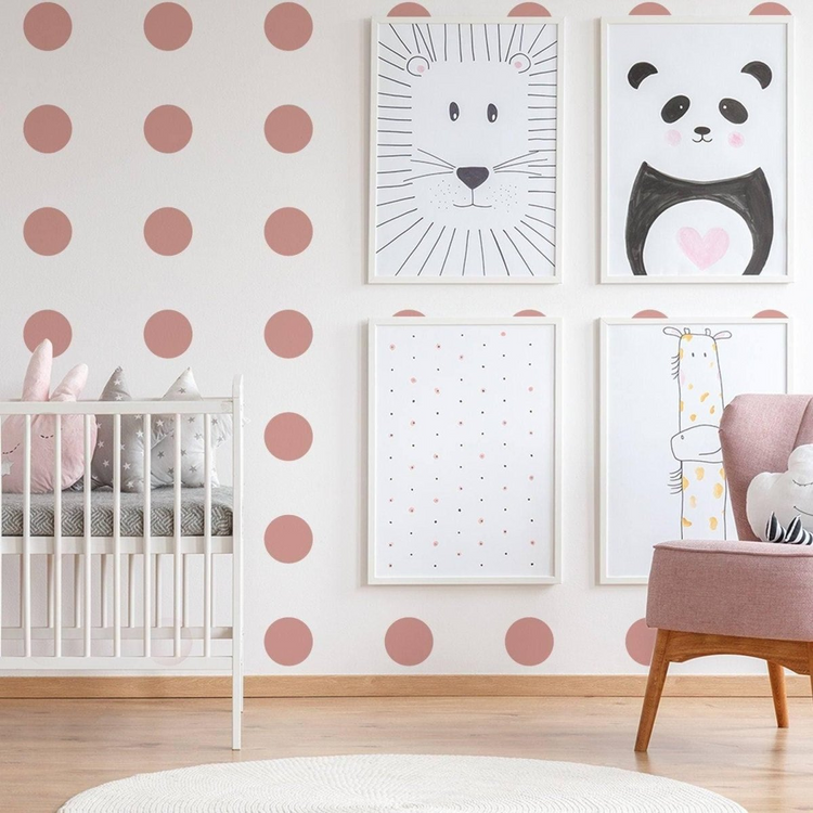 a room with pink polka dots and pictures on the wall