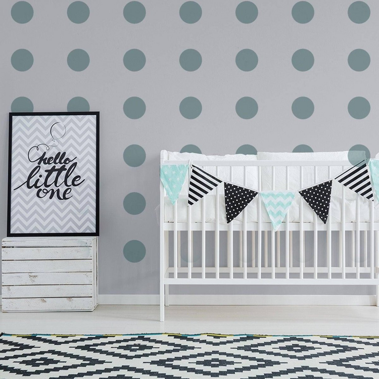 a baby crib with a bunting and a poster on the wall
