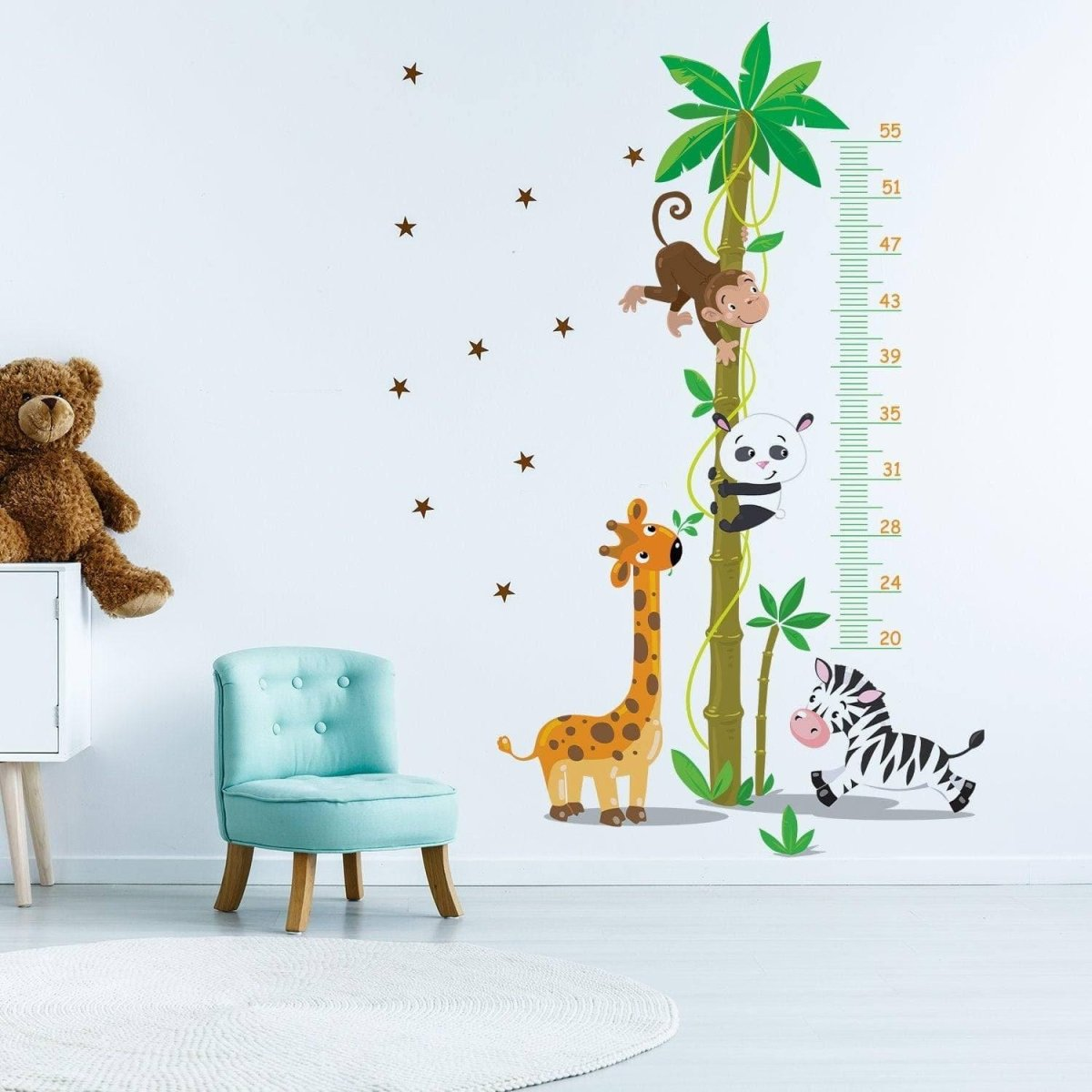 a wall decal with animals and a teddy bear