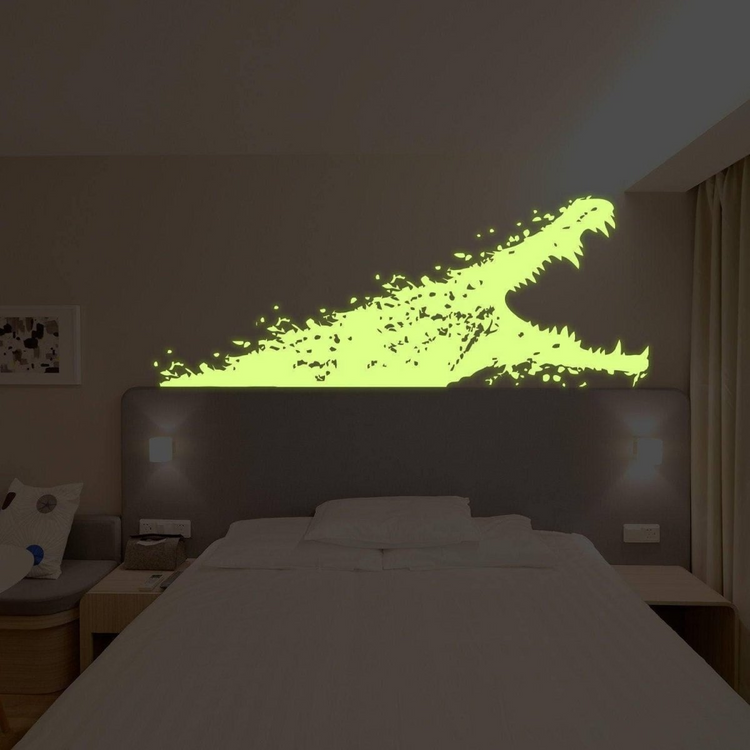 a bed with a dinosaur headboard