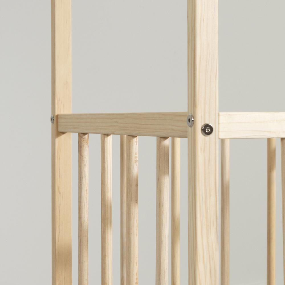 a wooden crib with a metal rod