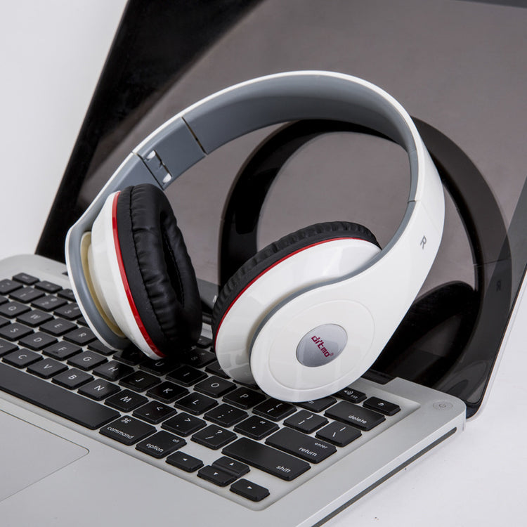 a white headphones on a laptop keyboard