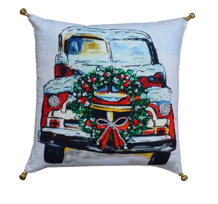 a pillow with a picture of a truck and wreath