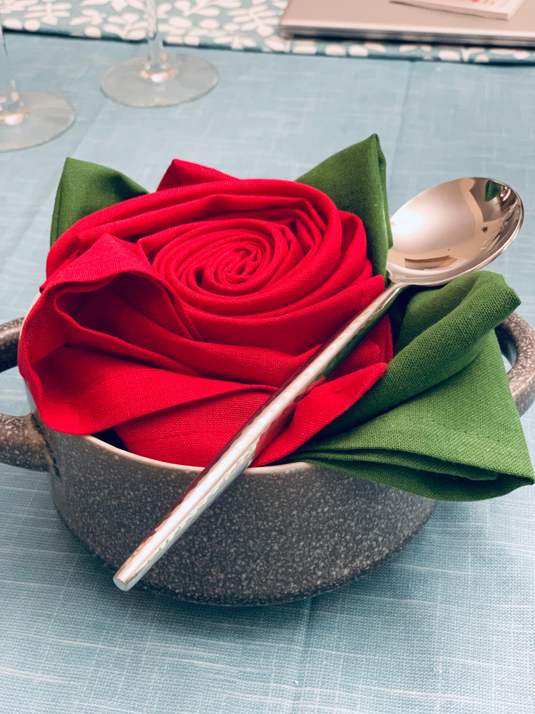 a napkin in a rose shaped dish