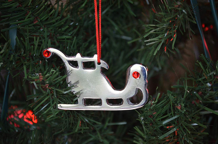 a silver ornament on a tree
