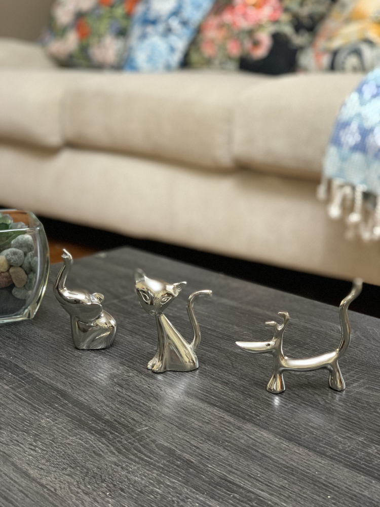 a group of silver animal figurines on a table