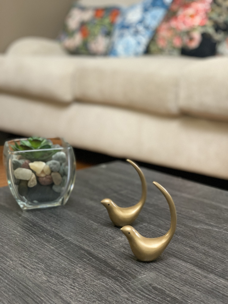 two gold birds on a table
