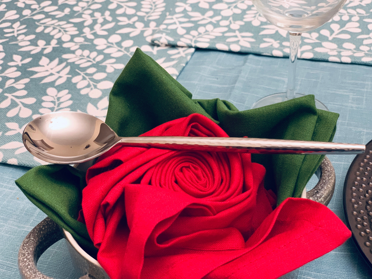 a spoon in a bowl of napkins