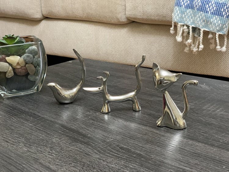 a group of metal figurines on a table