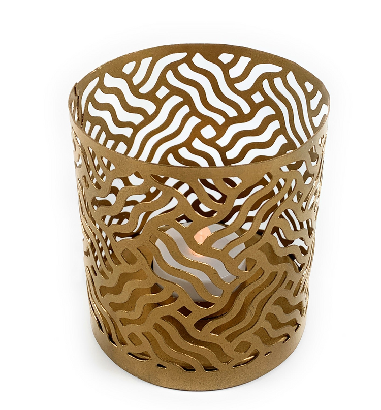 a gold candle holder with a candle