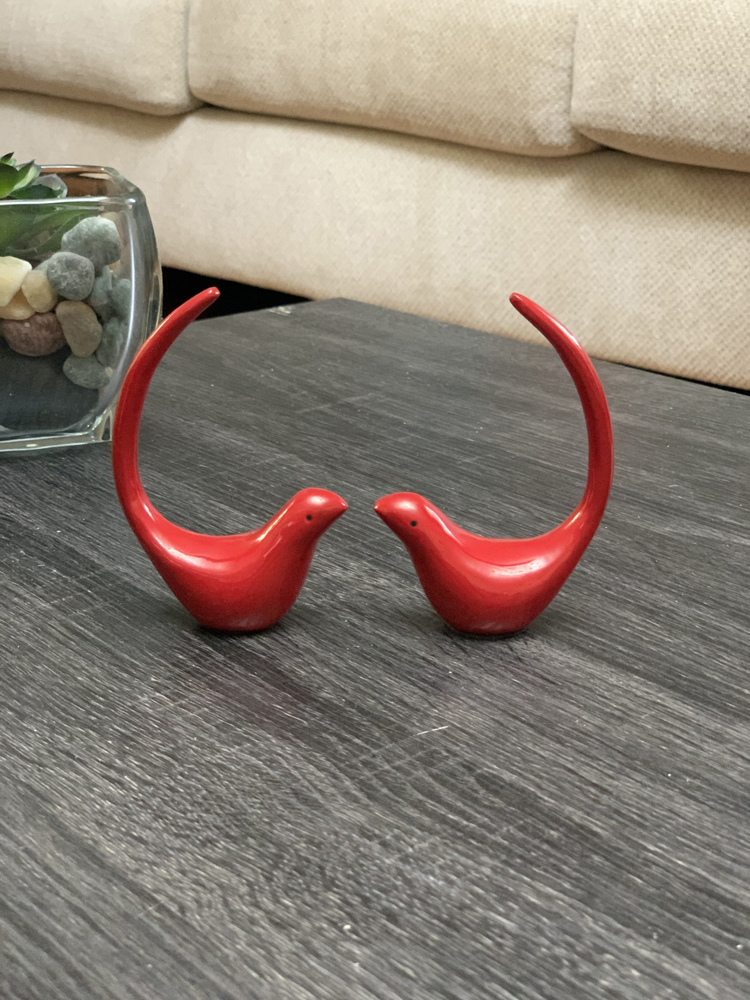 two red birds on a table