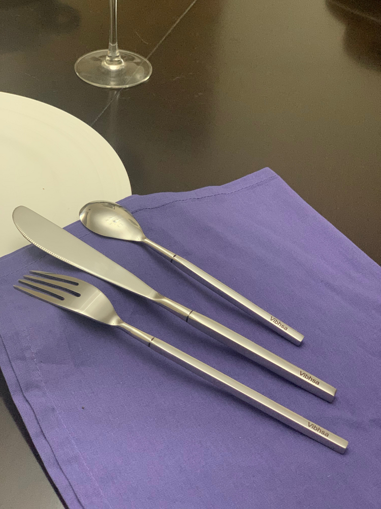 a silverware on a purple napkin