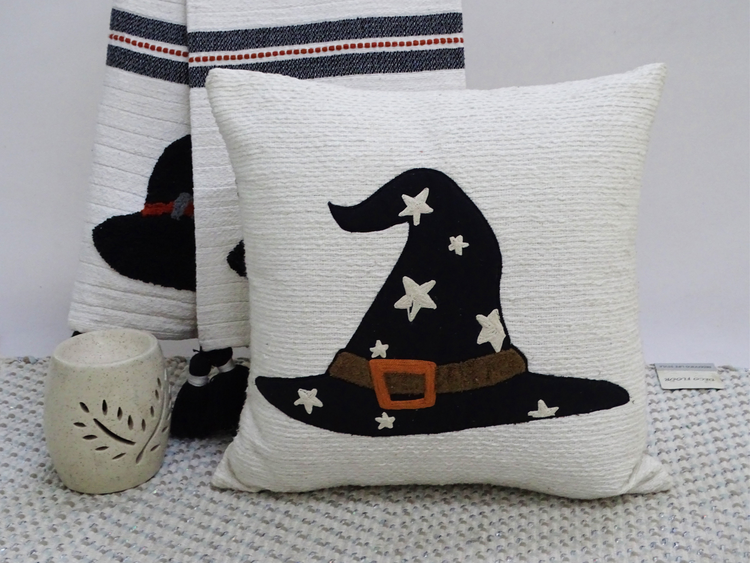 a white pillow with a black hat on it