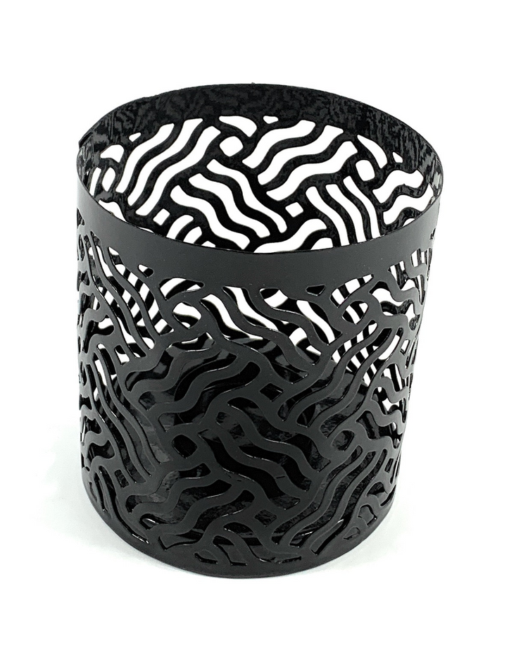 a black metal container with a pattern