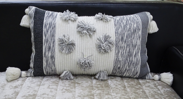 a pillow with tassels on it