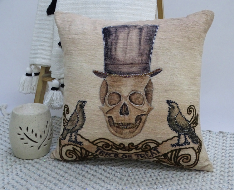 a pillow with a skull and birds on it