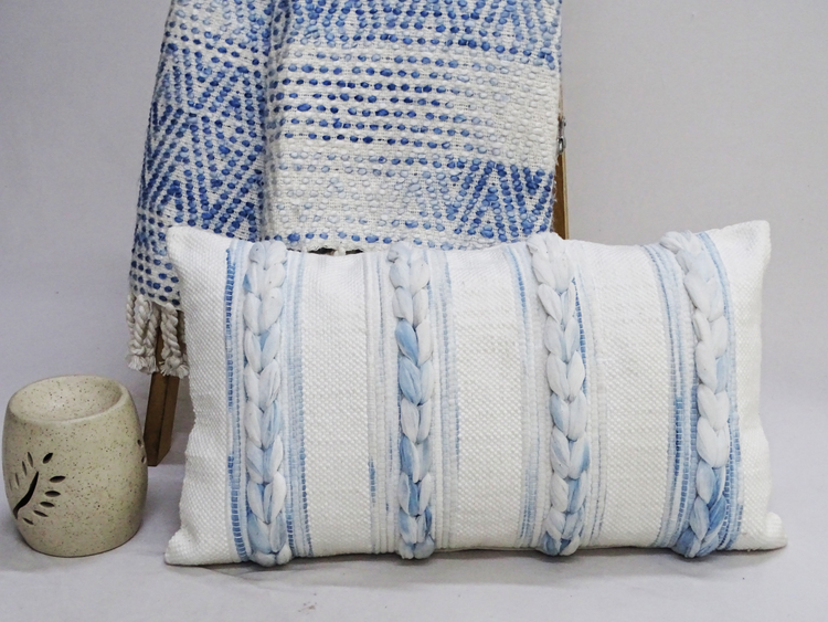 a pillow next to a blanket