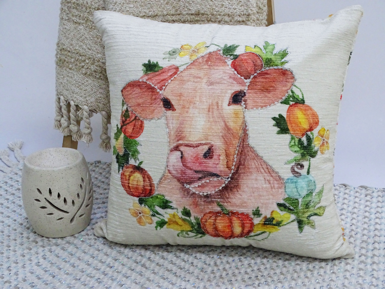 a pillow with a cow painting on it