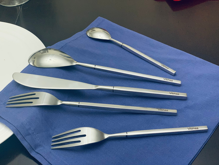 a group of silverware on a blue napkin