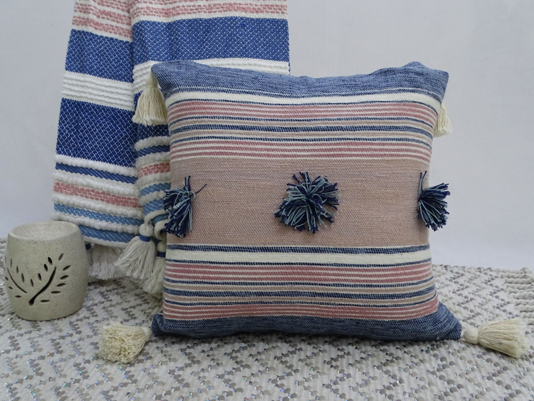 a pillow with tassels on it