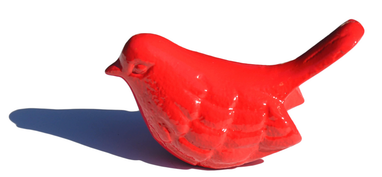 a red bird statue on a white background