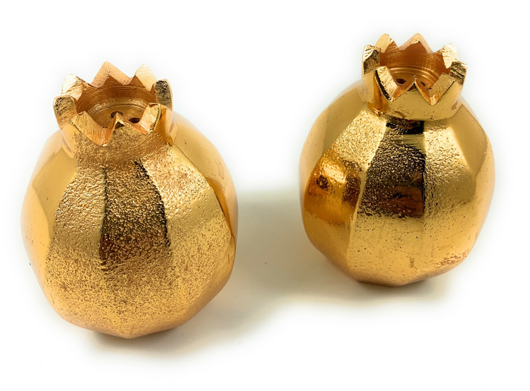 two gold objects on a white background