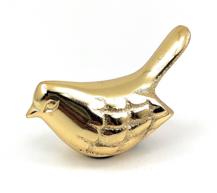a gold bird statue on a white background