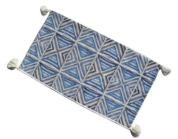 a blue and white rug with white and gray squares