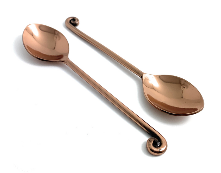a pair of copper spoons