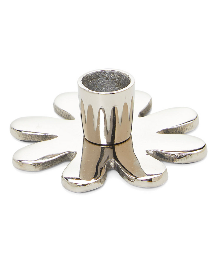 a silver candle holder with a splatter