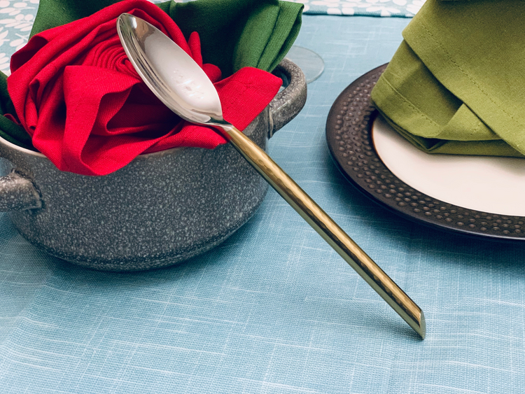 a spoon in a bowl of napkins