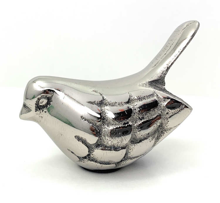 a silver bird statue on a white background