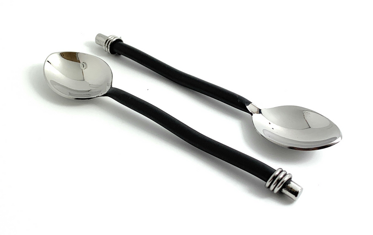 a pair of spoons with black handles