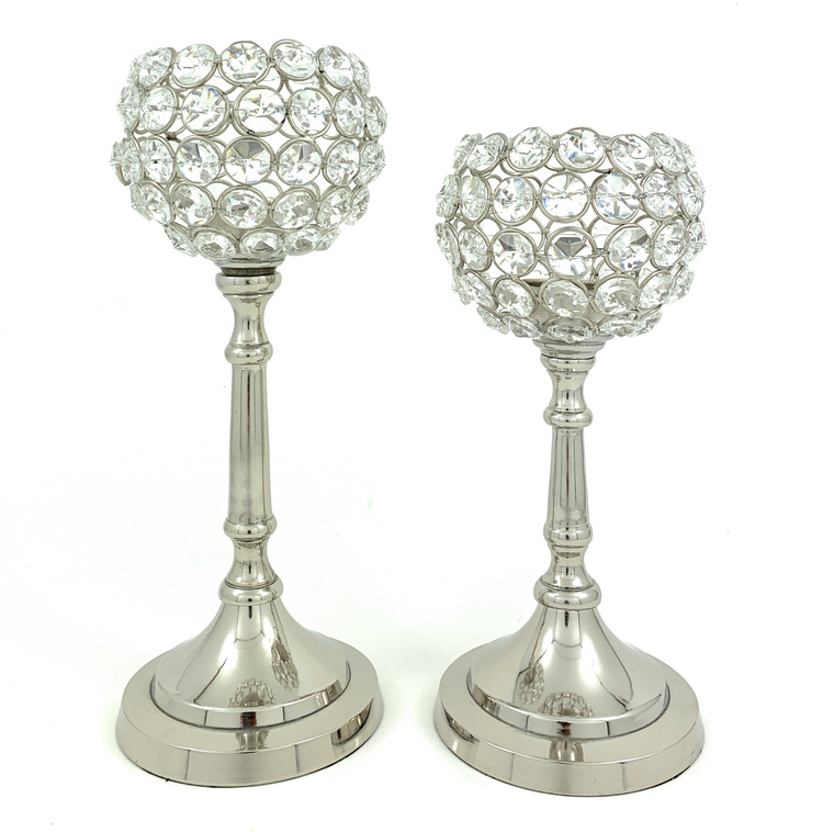 a pair of candlesticks with crystals