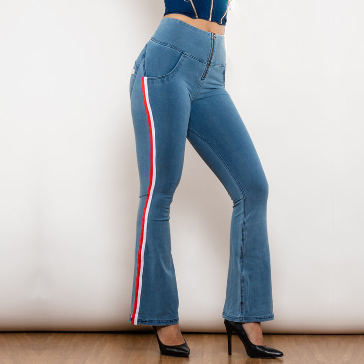 a woman wearing blue jeans and black high heels