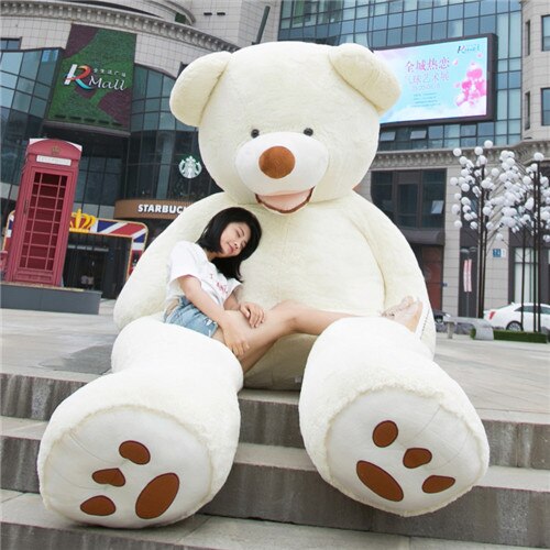 a woman sitting on a large teddy bear
