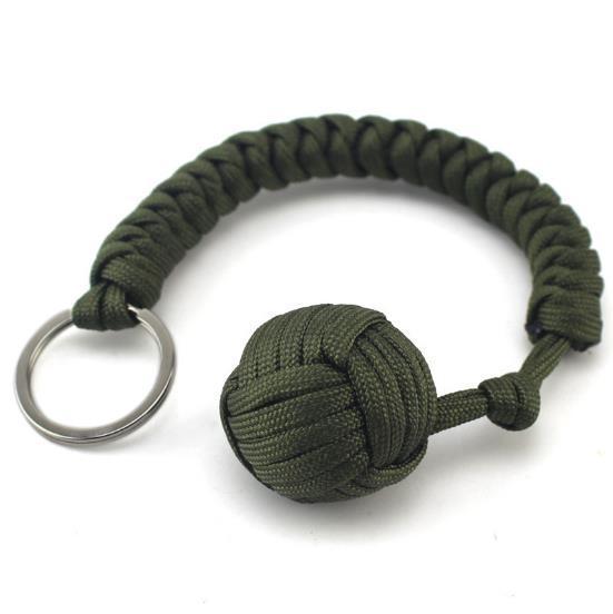 a green keychain with a ball