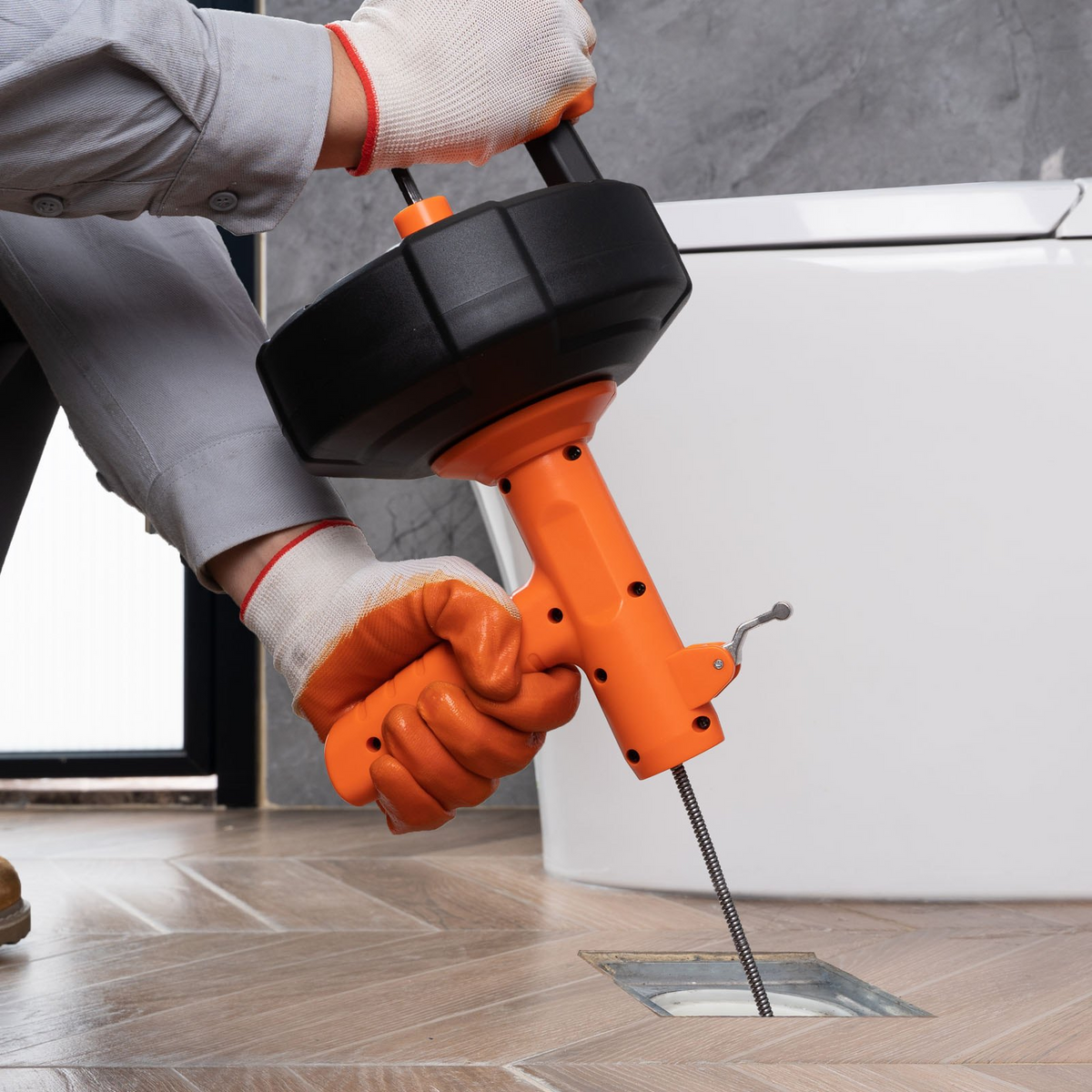 a person using a drill to drill a hole in a tile floor