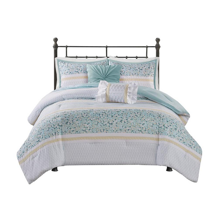 a bed with a white and blue bedding