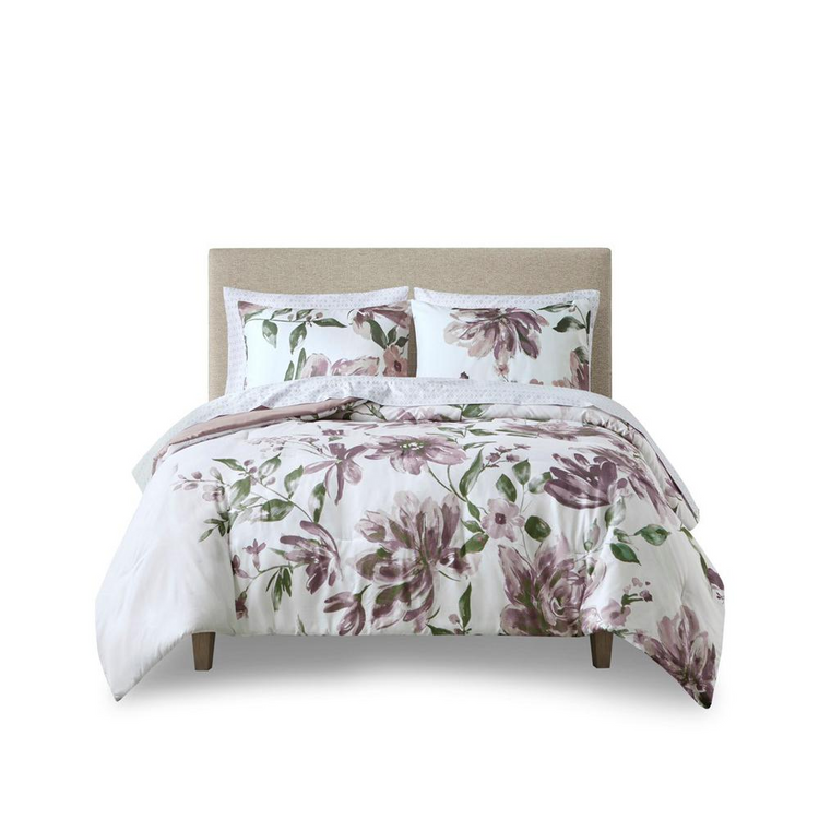 a bed with a floral comforter