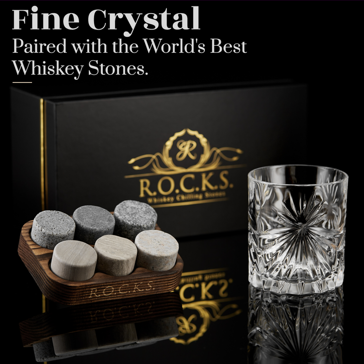 a glass and a box with stones on it