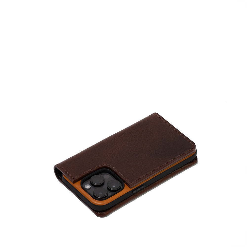 a brown leather case with three black circles on it